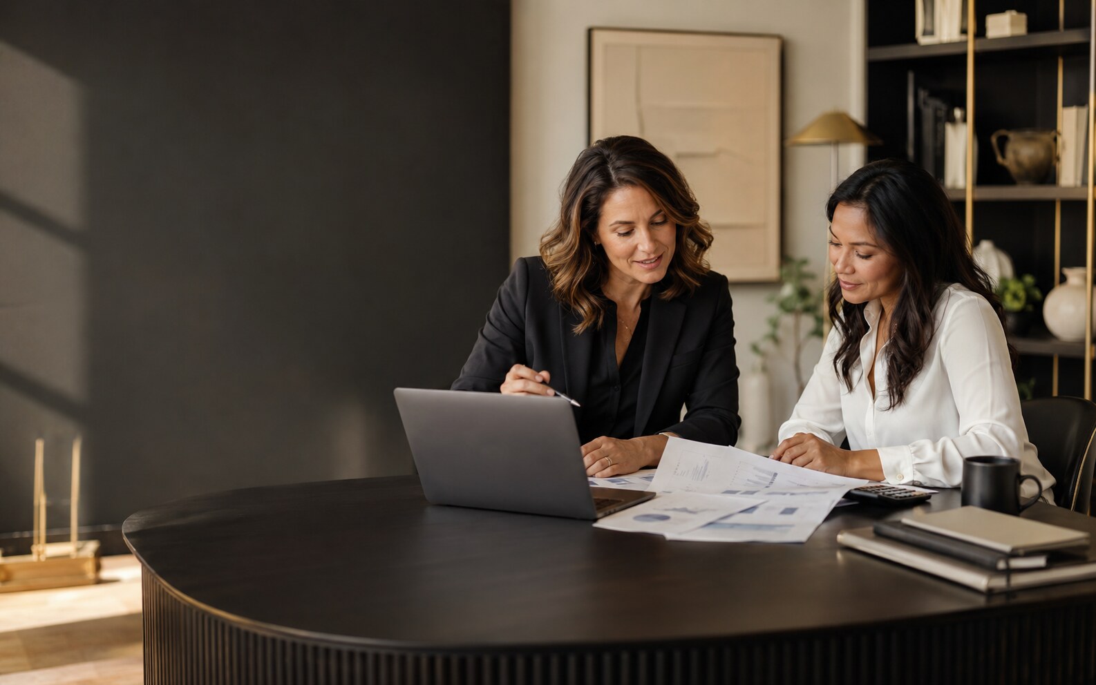 Financial consultant reviewing business reports with a client
